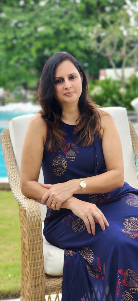 Parul Sethi, founder of Xpressions, seated outdoors in a calm garden setting
